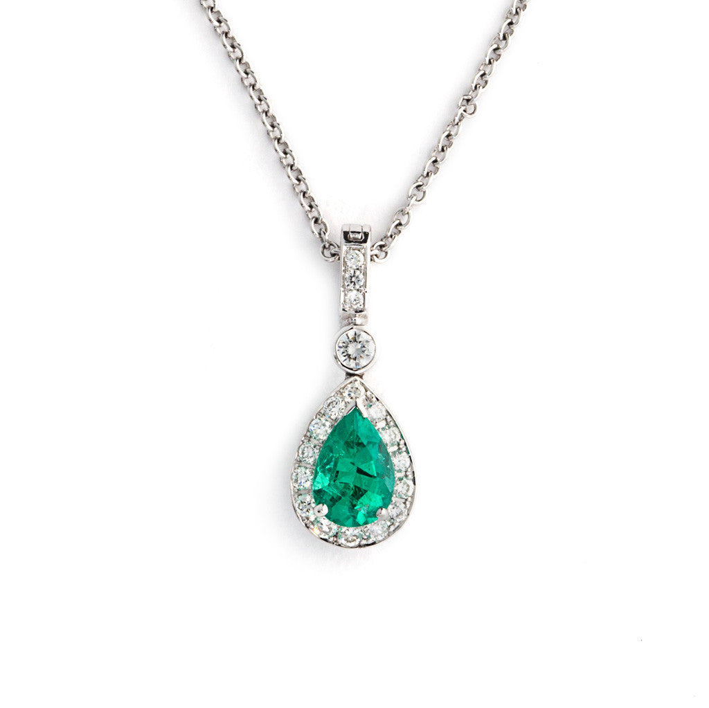 Pendant of Pear Shaped Natural Emerald surrounded by white diamonds.