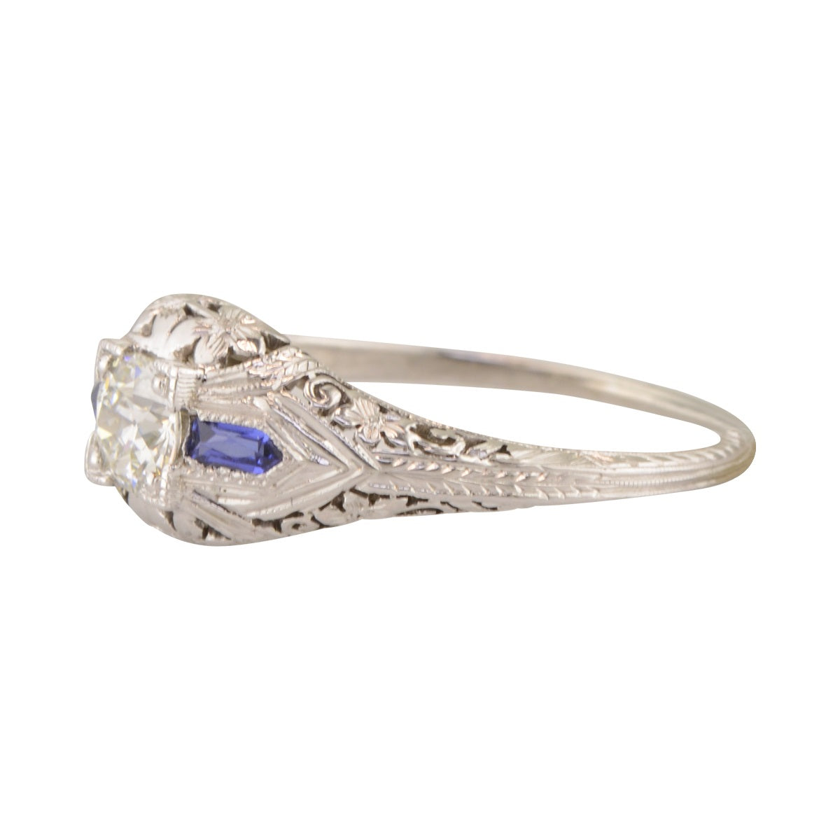 Filigree white gold engagement ring with sapphire accents. 