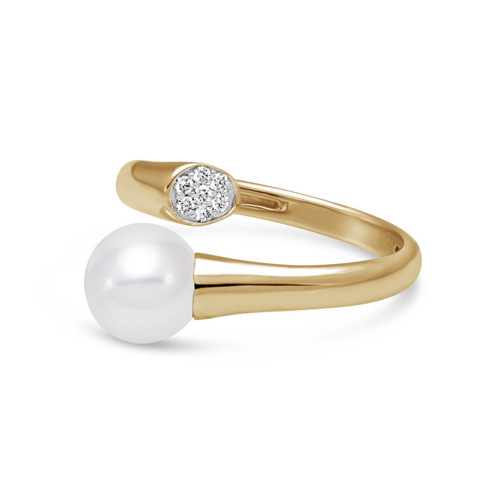 Dramatic pearl and gold ring with diamond accent.