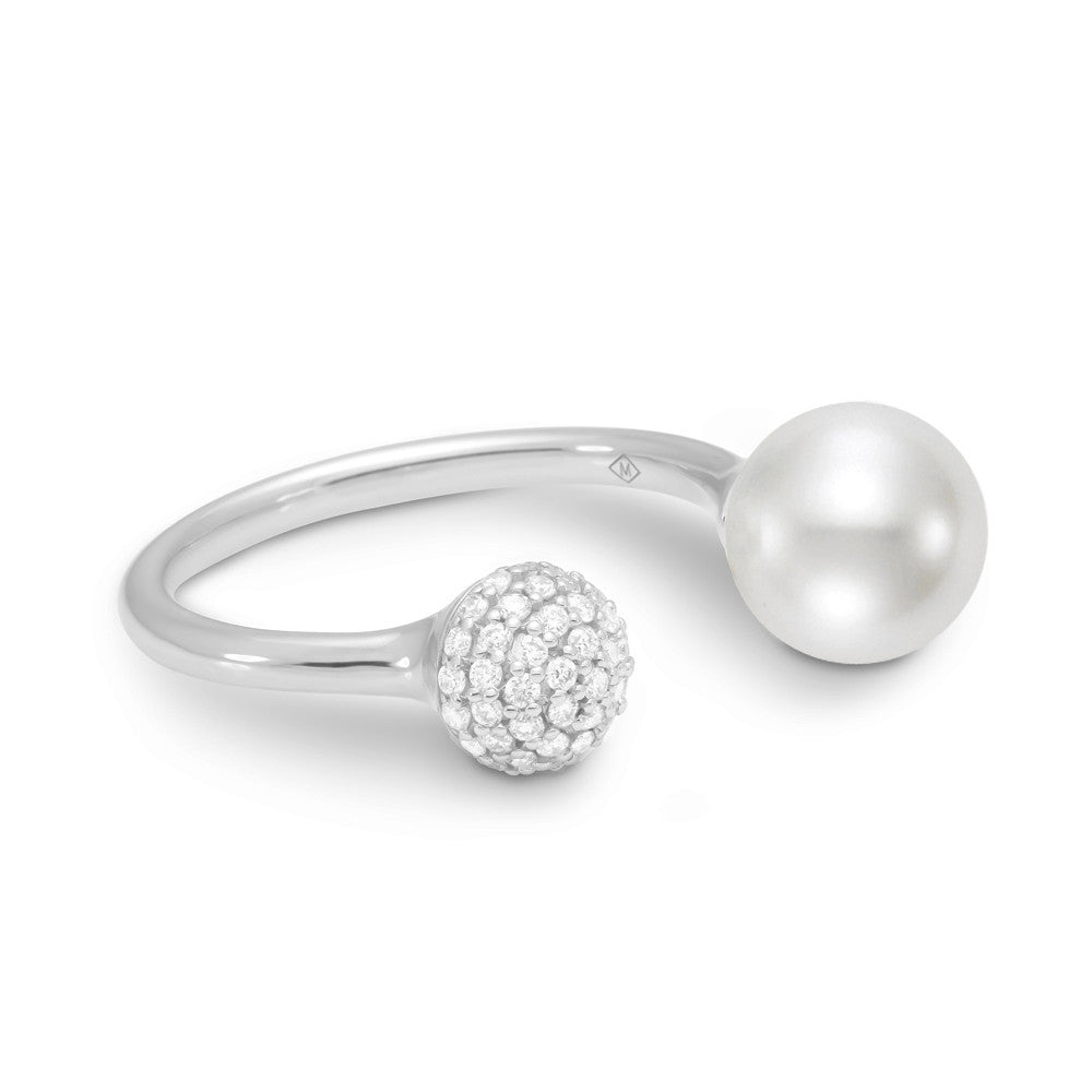 A brilliant white pearl and diamond pave ball center this very modern ring. 